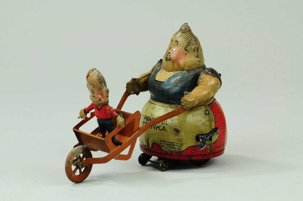 POWERFUL KATRINKA WITH JIMMY IN WHEELBARROW: Copr. dated 1923 Fontaine Fox, Geo. Borgfeldt Nifty brand toy made by H. Fischer Germany, lithographed wind up toy, Toonerville character, sometimes billed as the strongest woman in the world, lifts t