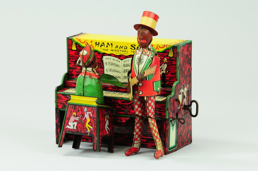HAM AND SAM MINSTREL BAND: Ferdinand Strauss, lithographed tin, familiar duo with clockwork driven piano, seated and standing musicians. 6 1/2" w.
