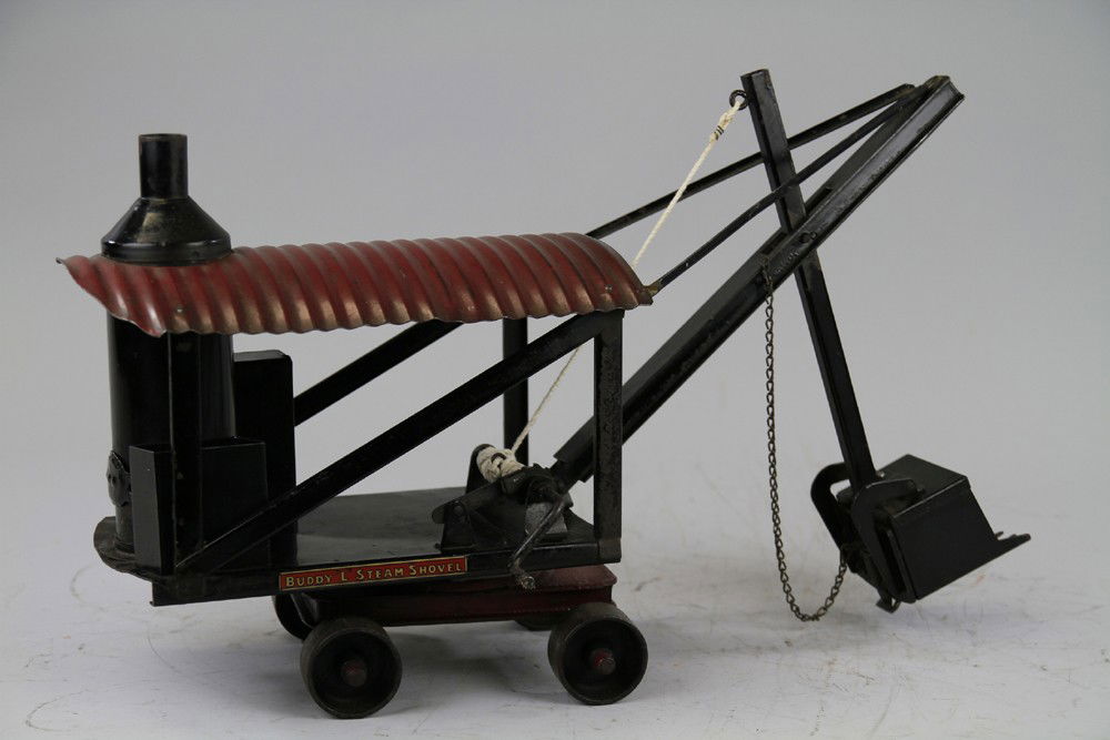 BUDDY 'L' STEAM SHOVEL: C. 1920's, pressed steel, vertical boiler on frame housing, red corrugated roof, roller wheels, black scoop shovel, swivel base. 21" l.
