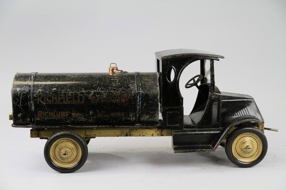 RICHFIELD GASOLINE TRUCK: American National, pressed steel model, well detailed Mack cab painted black, tank body, contains decals on sides, frame and spoke wheels done in yellow. 28" l.