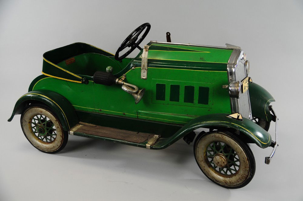 AMERICAN NATIONAL PACKARD PEDAL CAR: Early pressed steel example, painted in green body, nickel trim and appointments, an all original piece, Packard medallion on grille, full fenders and running boards, side horn, simulated top down mod