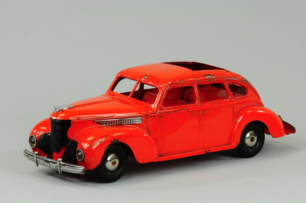 1939 KINGSBURY DESOTO: Pressed steel, painted in bright orange, features opening sky view roof, nickel trim, clockwork mechanism. 14" l.