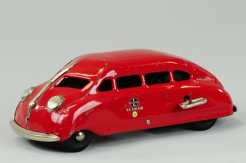BUDDY 'L' SCARAB: C. 1936, pressed steel, painted in red overall, streamlined design, clockwork mechanism, nickel dummy lights, decals on sides. 10 1/2" l.