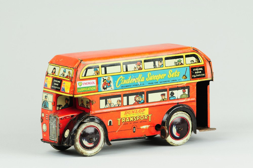 ENGLISH TRANSPORT DOUBLE DECKER BUS: Wells-O-London, lithographed tin, wind-up action, features advertising on all sides, passenger graphics at windows, disc wheels. Some replaced paper ads. 8" l.