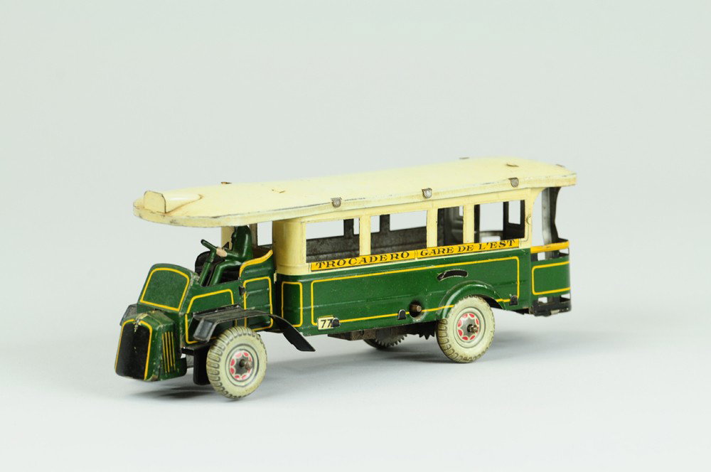 ROSSIGNOL PARIS INTER CITY BUS: Lithographed tin, done in green body, white roof, clockwork with driver, sides read "Trocadero-Gare de L'Est" destinations. 8 1/2" l.