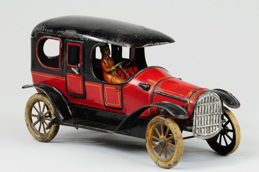 KARL BUB LIMOUSINE: Germany, lithographed tin, opening passenger doors, red body, black roof and running boards, clockwork driven, spoke wheels. 11" l.