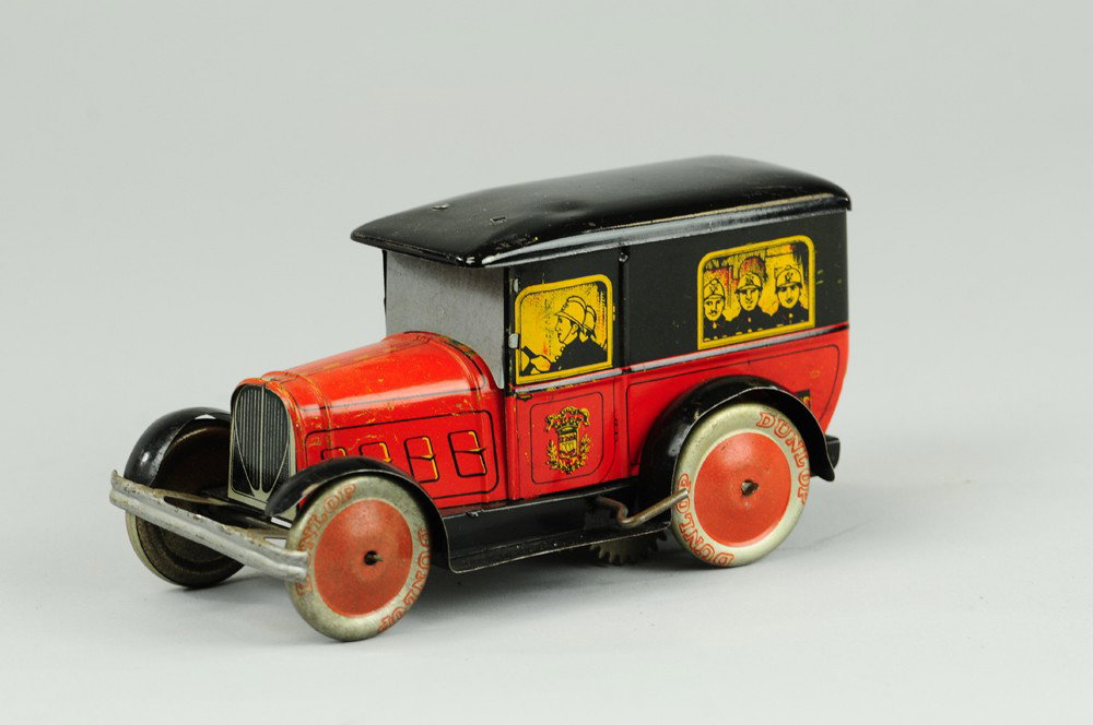 DE ANDREIS FIRE TRUCK: France, lithographed tin, done in red and black, graphic images of firemen at windows, roof lifts revealing clockwork. 6 1/2" l.