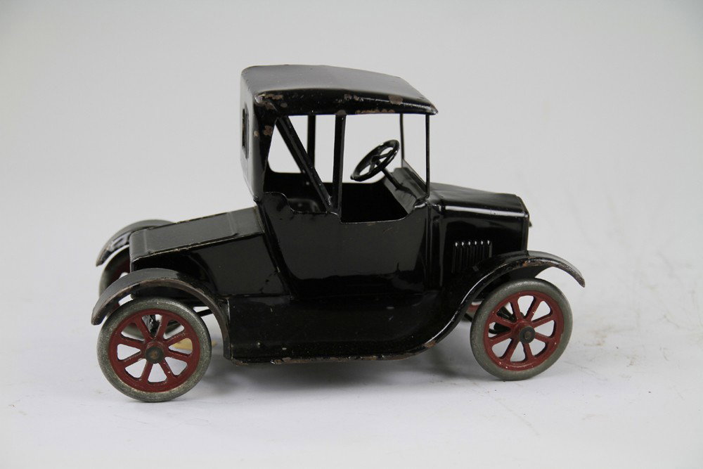 BUDDY 'L' FLIVVER MODEL 'T' ROADSTER: Pressed steel, painted in black overall, soft top design, spoke wheels have red centers, original paint and decals. 12" l.