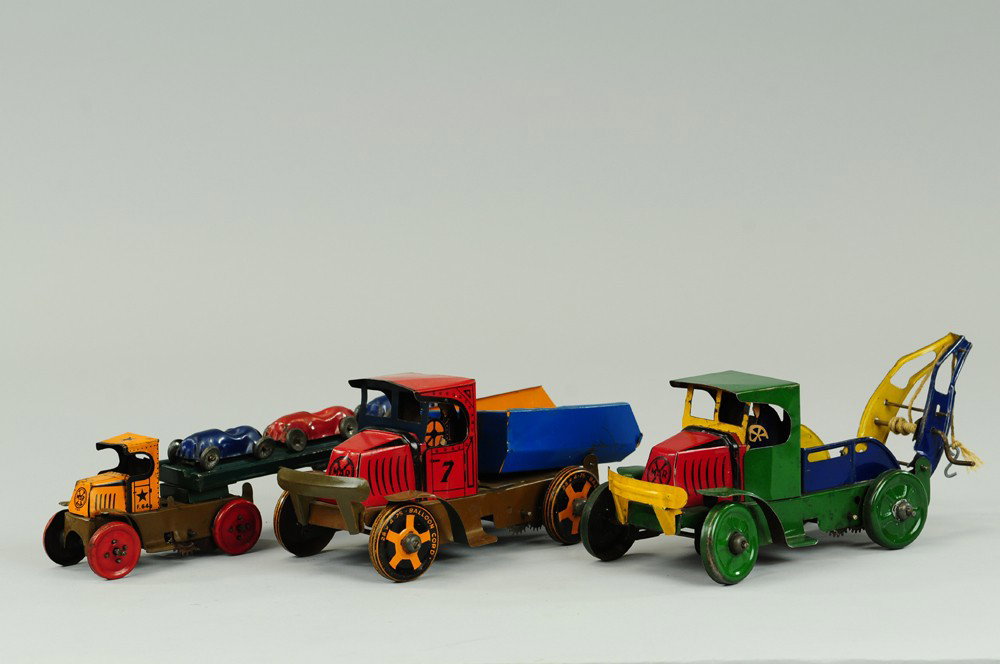LOT OF THREE MARX VEHICLES: Tin litho Mack Cab trucks, includes: wrecker, dump and car transport, very colorful. 9 1/2"-12" l.