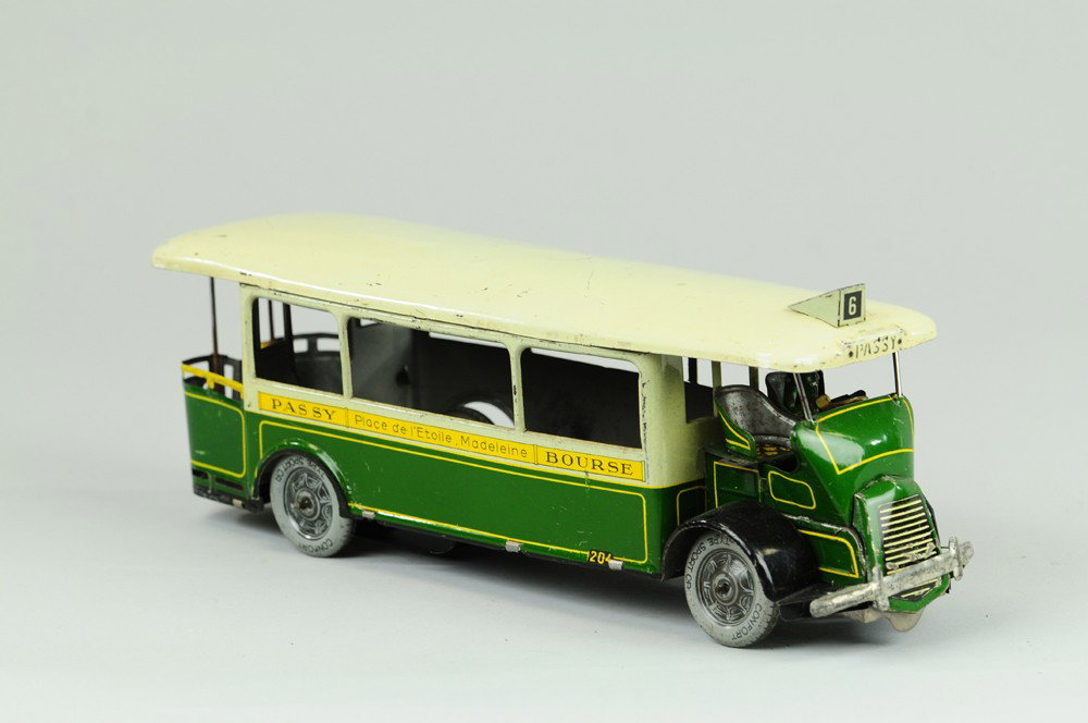 ROSSIGNOL "PASSY" AUTOBUS: France, lithographed tin, done in green and white body, white roof, seated driver, circa 1930's intercity bus w/ ads on sides, clockwork driven. 11 1/2" l.