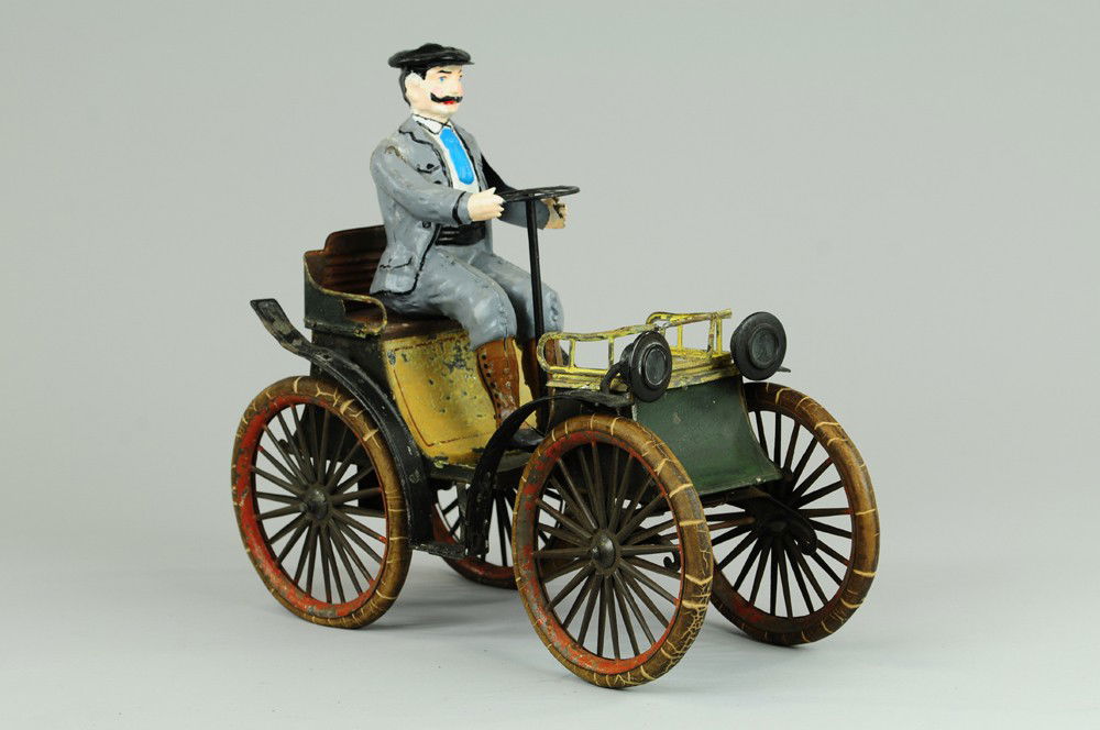 GUNTHERMANN VIS-A-VIS: Germany, c. 1895, large scale open auto with hand painted seated figure, lithographed tin body, head lamps on curved hood, rubber tires, spoke wheels, works well. 9 3/4" x 3 3/4"