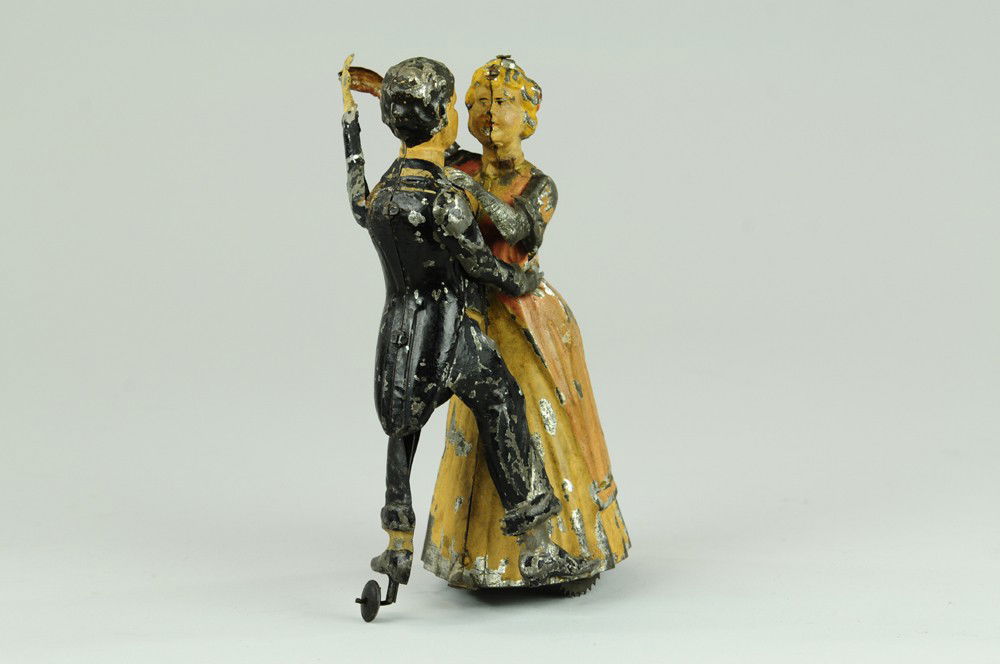 TANGO DANCERS: Gunthermann, Germany, hand painted tin, delightful toy rendition of two dancers, colorfully painted performing tango when clockwork is activated. 8" l.