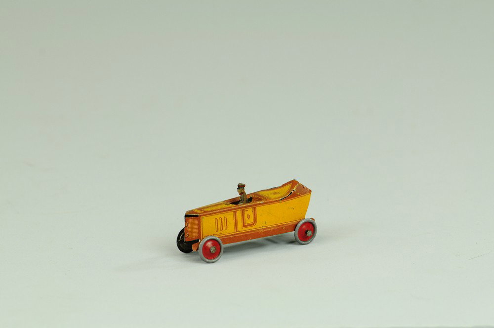 FISCHER RACER PENNY TOY: Germany, small scale lithographed tin, done in orange and brown trim body, seated driver, disc wheels, boat tail rear. ?? 1/2" l.