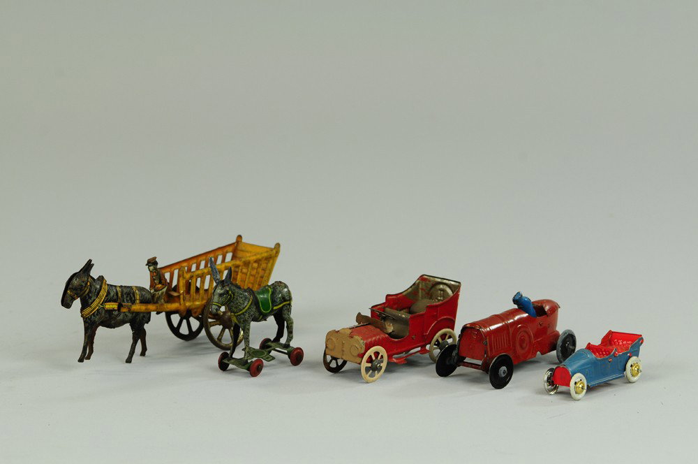 GROUPING OF PENNY TOYS: Assorted lot includes: one-color race car, two open autos, together with Donkey on Platform and Donkey drawn farm cart w/seated driver. 2 1/2"-6" l.