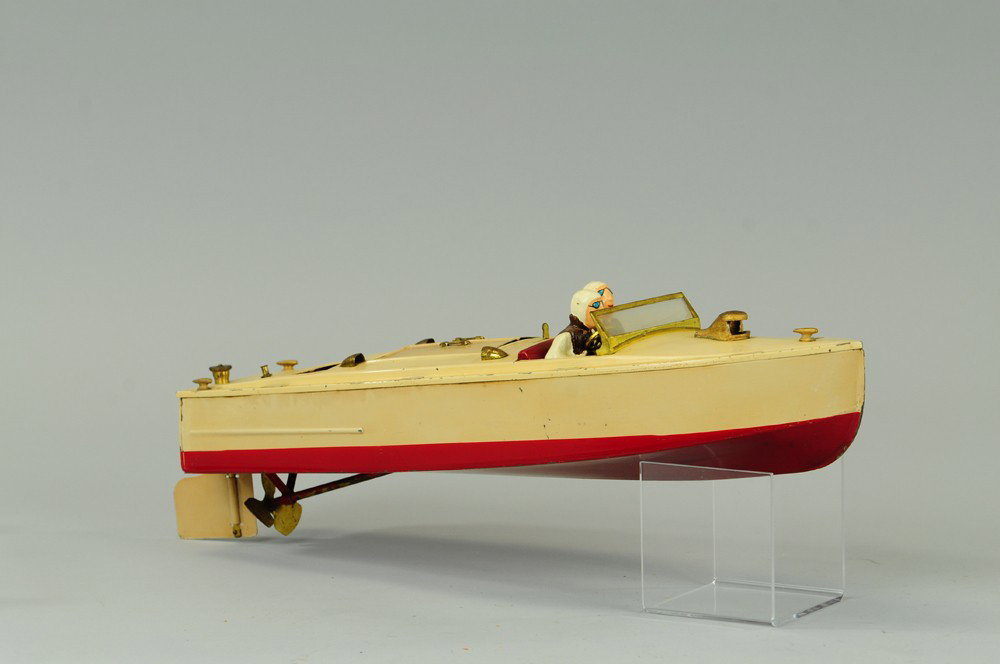LIONEL DOUBLE SEAT SPEEDBOAT: C. 1934, pressed steel, done in cream w/red seating and hull bottom, features seated drivers, clockwork driven, concealed in deck hitch. 16"l.