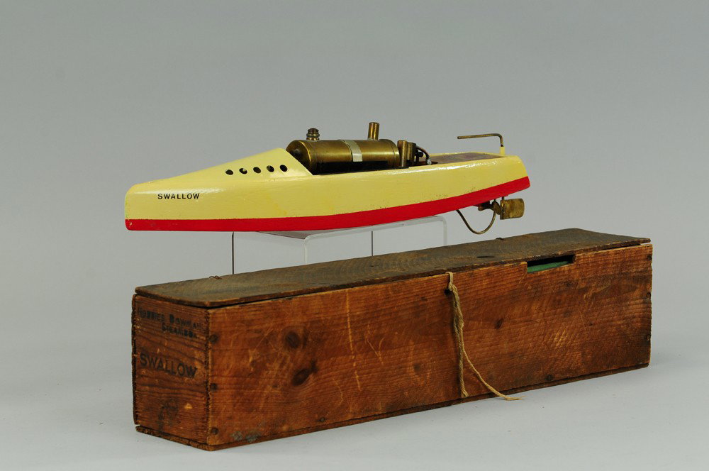 BOWMAN "SWALLOW" STEAM POWERED SPEEDBOAT: Boxed example, wooden painted hull w/pressed steel bow and horizontal boiler, done in yellow and green overall, wooden box stenciled. 26"l.