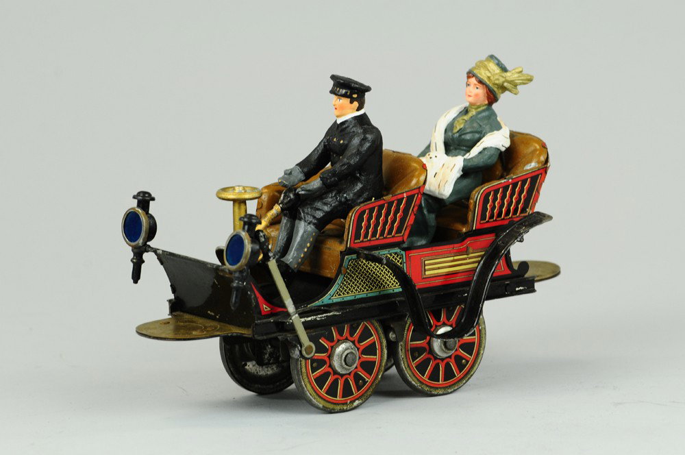 EARLY HESS FOUR SEAT AUTO: Germany, c. early 1900's, lithographed tin, heavily embossed seating, friction powered, one of the first versions of the street auto as we know it today, very unique styling and surprisingly ergonomic