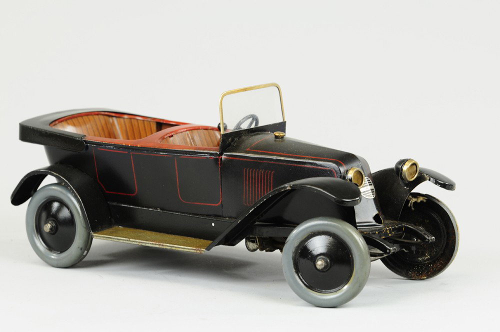 RENAULT K2 TORPEDO: JEP, France, c. 1928, luxury auto done in black with red pin striping, lithographed tin seating and running boards, well detailed gear mechanism, clockwork driven, celluloid windshields. 13" l.