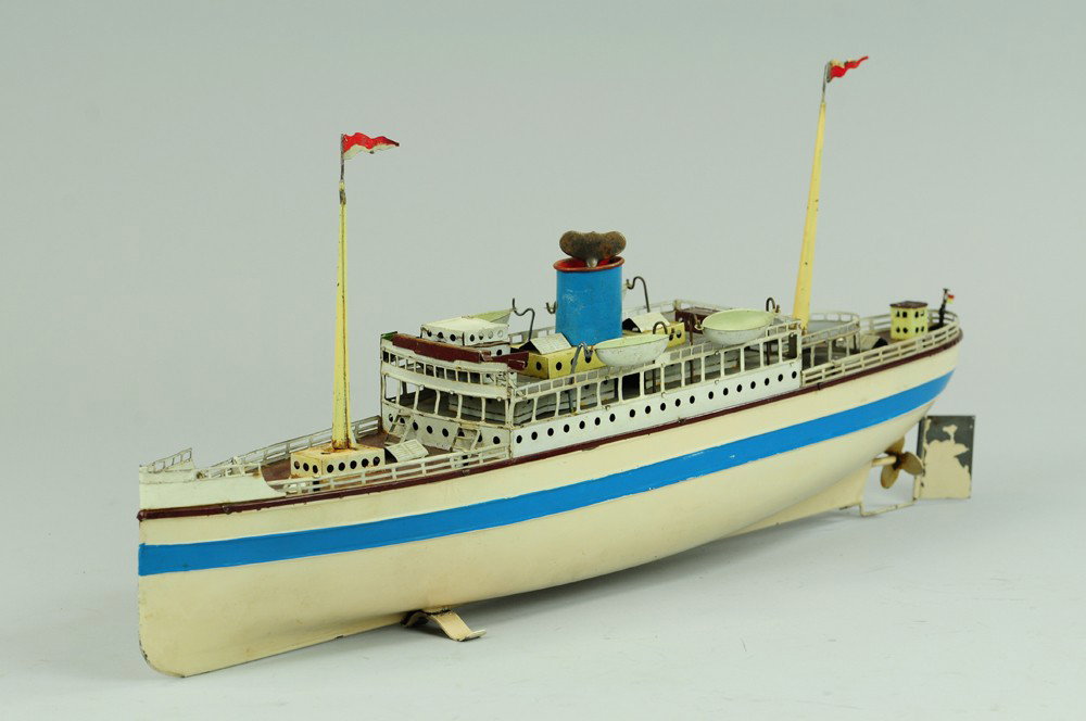 FLEISCHMANN PASSENGER SHIP: Painted tin toy ship, done in classic white and blue, upper deck cabin, lifeboats, two masts, clockwork motor. 20 1/2" l.