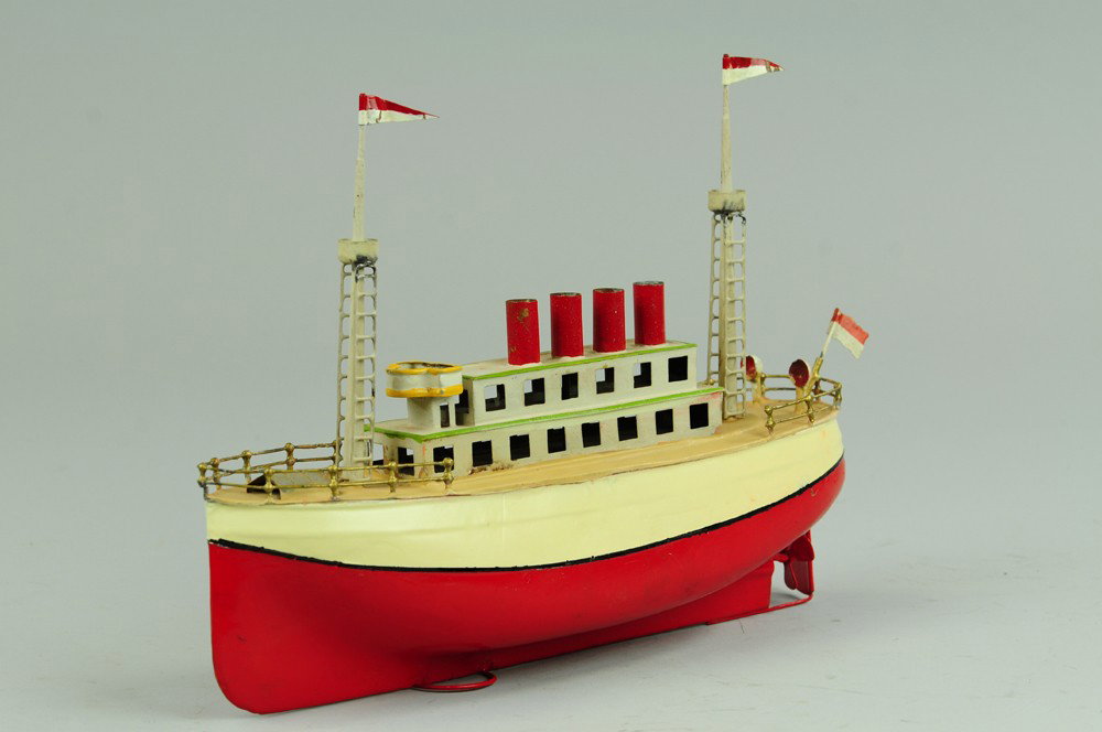 PASSENGER SHIP: Germany, Fleischmann for Carette, repainted in red and white hull, tan deck, white upper deck cabin, two observation masts, clockwork driven. 12" l.