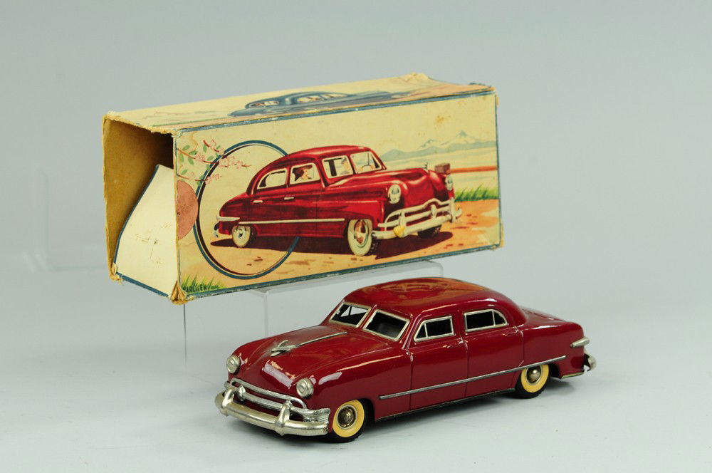GUNTHERMANN SEDAN: Lithographed tin body, done in maroon, rubber tires, clockwork driven, nickel bumpers. 10 3/4" l.