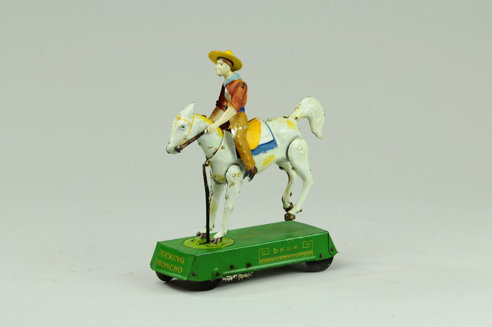 LEHMANN WILD WEST BUCKING BRONCO (WHITE HORSE): Germany, lithographed and hand painted, curious depiction of cowboy being thrown off horse on clockwork driven base. 6" l.