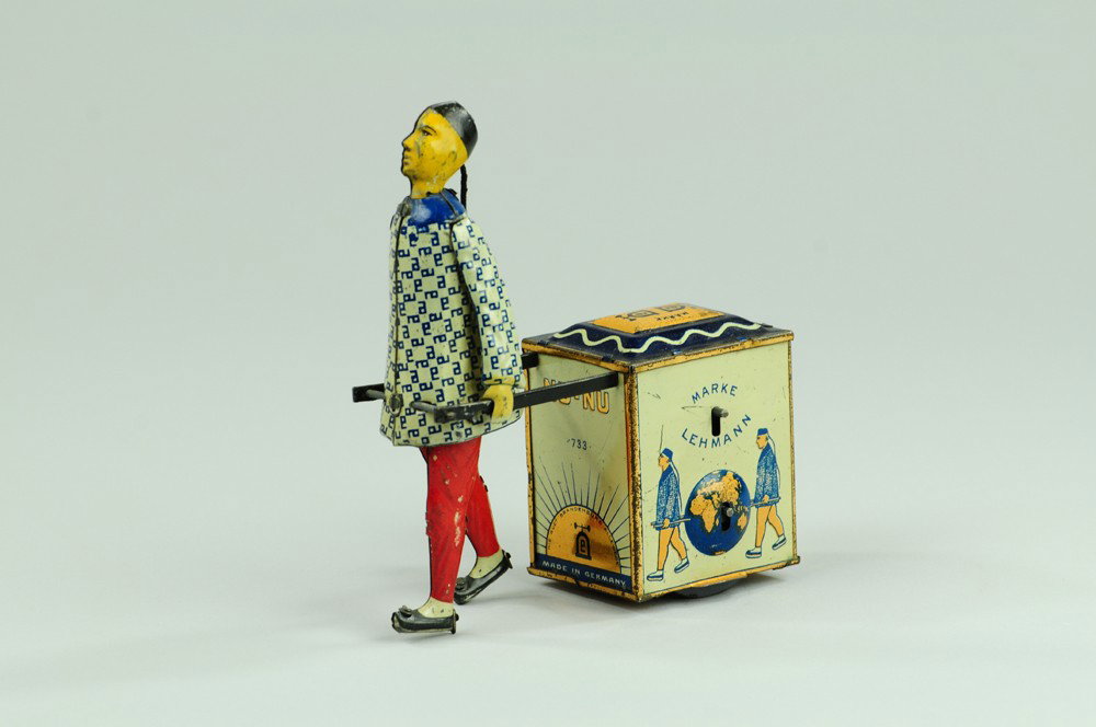 LEHMANN NU-NU: Germany, lithographed tin, colorful depiction of Chinaman pulling chest of tea, clockwork mechanism concealed within, wheels under chest allow easy motion 5" l.