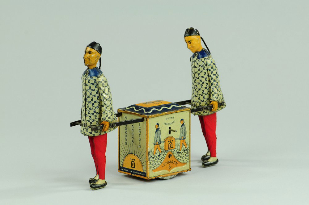 LEHMANN KADI: Germany, lithographed and hand painted tin, friction mechanism, depicts two Chinese figures hauling colorful tea chest. 7" l.