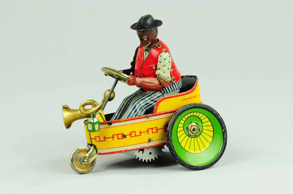 LEHMANN MIXTUM: Germany, lithographed tin, comical actions, black driver in barrel auto with horn and lantern, clockwork mechanism, boxed example. 4 1/2" l.