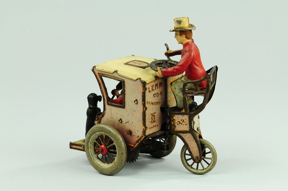 LEHMANN "LI LA" HANSOM CAB: Germany, lithographed and hand painted tin, coach driver seated at rear roof of cab holding two seated ladies and dog by footrest, clockwork action also includes woman putting umbrella through trap do