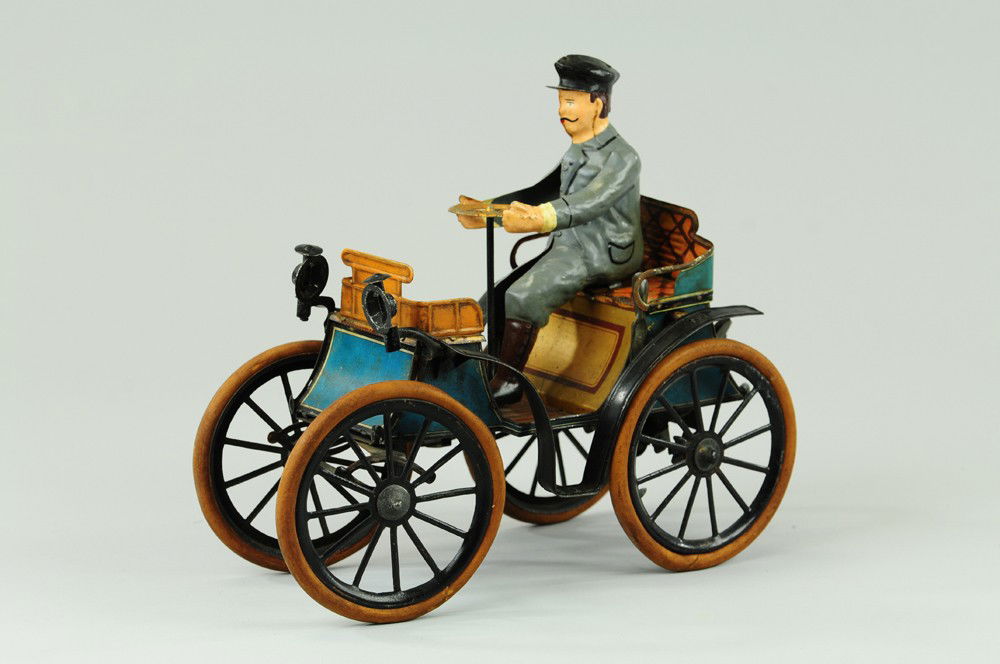 GUNTHERMANN VIS-A-VIS: Germany, c. 1895, large scale open auto w/hand painted seated figure, lithographed tin body, head lamps on curved hood, rubber tires, spoke wheels. 9 3/4" l.