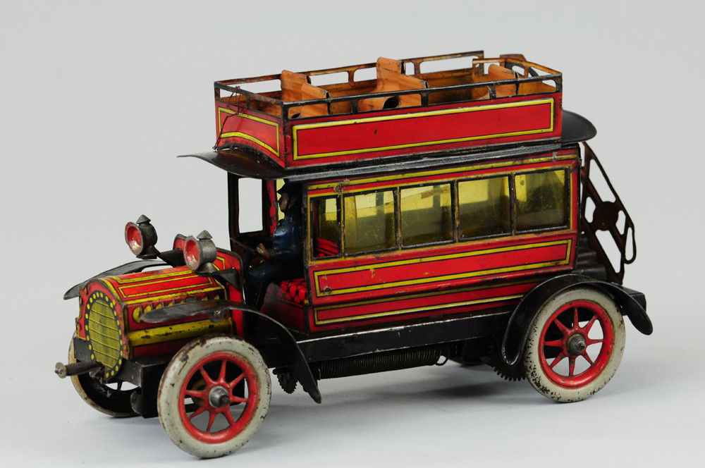 GUNTHERMANN DOUBLE DECKER BUS: Germany, c 1910, lithographed tin, well designed features glass windows, rear stairs, upper deck bench seating, cast lamps, seated driver and clockwork mechanism, very desirable and scarce example. 10