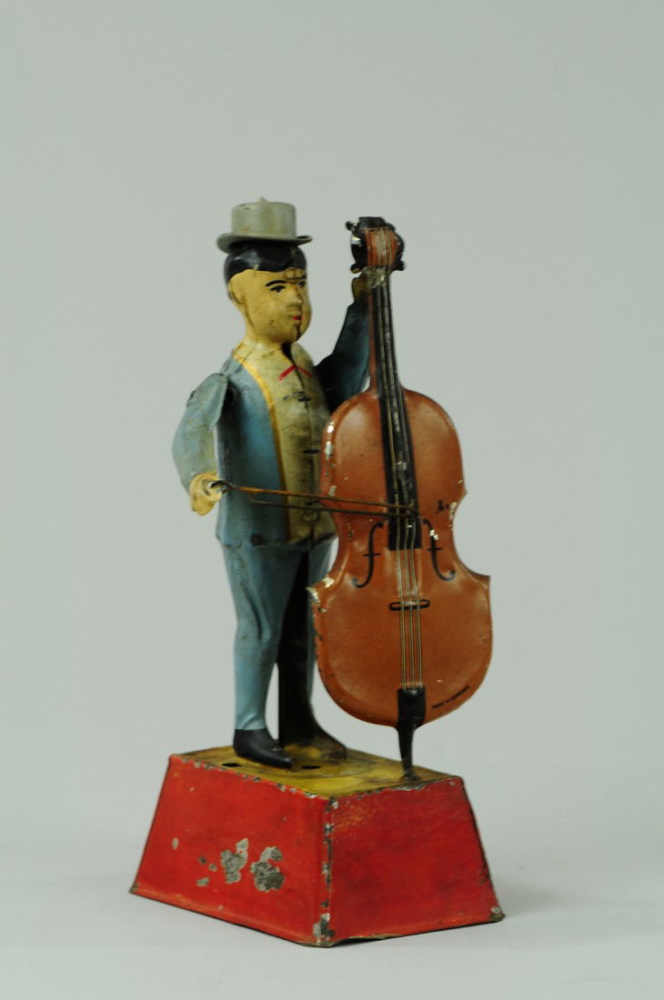 MAN PLAYING BASS: Germany, Gunthermann, whimsical depiction of standing figure holding bass and bow in hand, able to emit sound when clockwork is activated, great action. 10" h.
