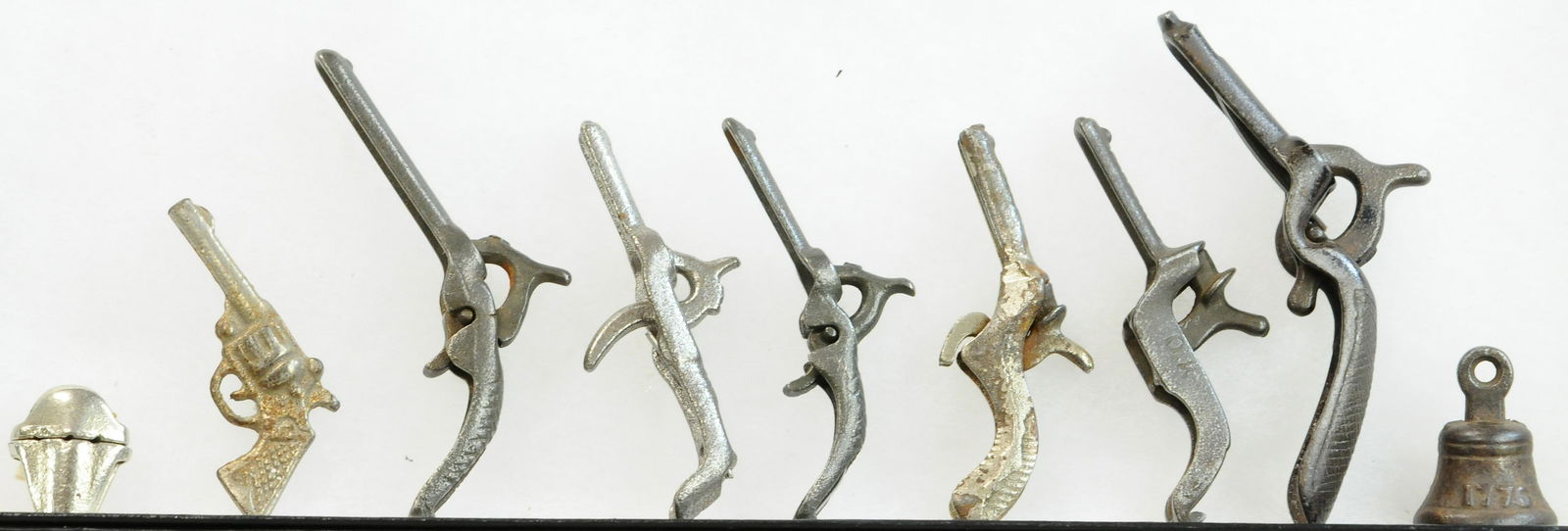 SEVEN TINY CAP GUNS & CAP BOMBS: 180. SEVEN TINY CAP GUNS & CAP BOMBS | One nickel gun and cast iron bell are not cap shooters, others working. The Schroeder Collection - Abbys Attic Finds 4.5" l. Overall in (Excellent Condition) $20