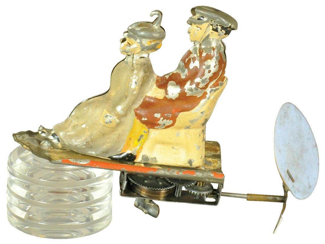 SEATED GERMAN COUPLE ON FLYING CARPET: 278. SEATED GERMAN COUPLE ON FLYING CARPET | The Schroeder Collection - Abbys Attic Finds 5.5" l. Woman's foot resoldered, missing one propeller blade and other replaced, working in (Very Good Conditi