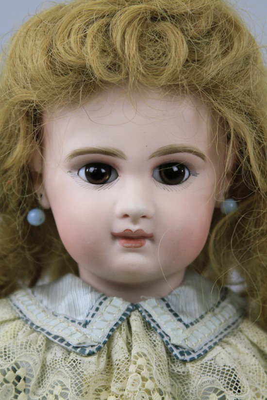 INCISED "DEPOSE JUMEAU" BEBE: Head incised "Depose Jumeau 9" and has brown paperweight eyes set in narrow almond shaped eye cuts and is on original fully jointed body stamped "Jumeau Medaille Dior," with straight wrists, she wears