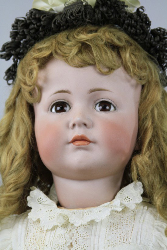 LARGEST KAMMER & REINHARDT "MEIN LIEBLING" DOLL: Beautiful example with closed mouth and brown glass sleep eyes, incised "K*R Simon & Halbig 117A 80," on original fully jointed body with original finish, wearing luxurious old auburn curly wig, dress