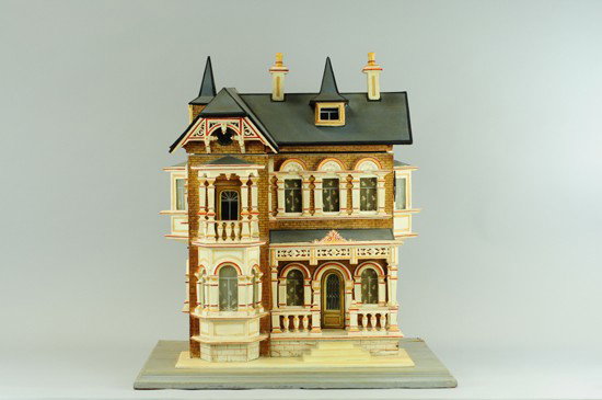 GOTTSCHALK VICTORIAN DOLLHOUSE: Germany, well detailed architectural dollhouse design, abundant trim work on three sides and gabled roof, front facade opens to reveal four rooms, three have papered walls and complete with furniture.