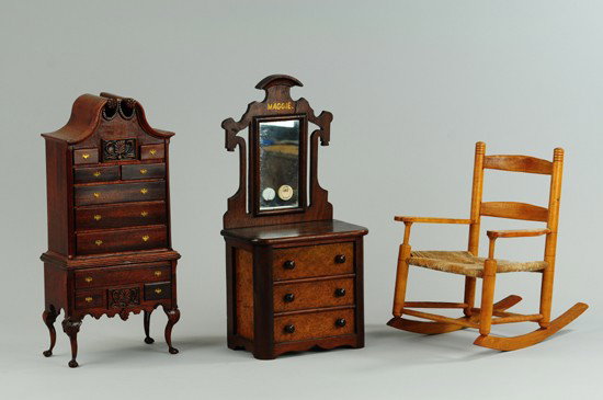 LOT OF THREE MINIATURE FURNITURE PIECES: Grouping includes: wooden rocking chair with woven seat, miniature dresser with mirror, and miniature high boy dresser with two opening drawers. SIZE