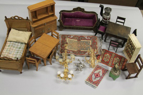 BOX OF MINIATURE FURNITURE: Assorted furniture and accessories for a doll's house, grouping features: chandeliers, wooden table, bed, upholstered couch and more miscellaneous in scaled detail. 2" to 8"