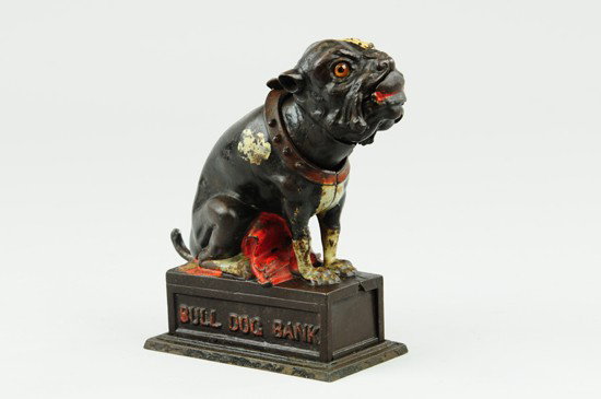 BULLDOG MECHANICAL BANK: Red blanket, J & E Stevens Co., designed by James H. Bowen, patented 4/27/1880. Place the coin on the nose of the dog, and as the tail is pulled, he will throw the coin off, catch it in his mouth, and