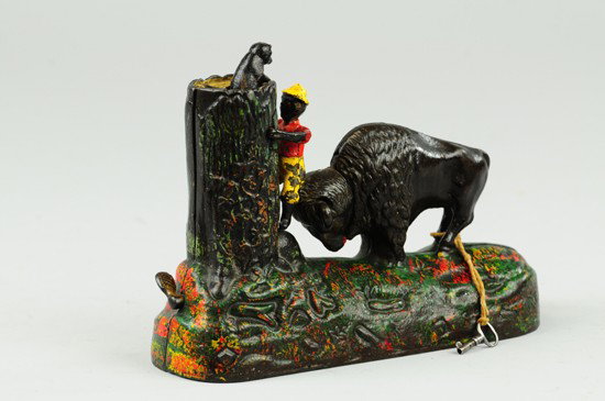 BUTTING BUFFALO MECHANICAL BANK: Kyser & Rex Co., designed by Alfred C. Rex, patented 3/20/1888. Place a coin in the slot and press the lever; the buffalo lifts his head as if butting the boy, the boy moves upwards attempting to view