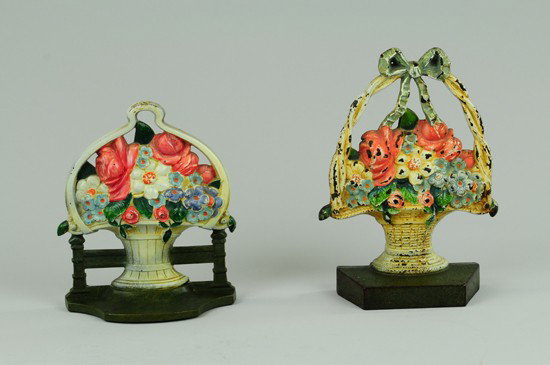 LOT OF FLOWER BASKET DOORSTOP AND BOOKEND: Doorstop is delightful casting with thick base depicting wicker basket with woven handle and green bow holding mixed bouquet together with bookend of mixed flower arrangement in white basket with orna