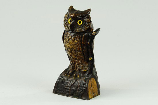 OWL, TURNS HEAD MECHANICAL BANK: Brown color, J & E Stevens Co., designed by James H. Bowen, patented 9/28/1880. The above bank has glass eyes and is nicely ornamented in natural colors. Place a coin on the top of the branch, and pre