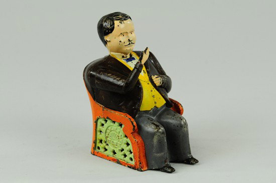 TAMMANY MECHANICAL BANK: Grey pants, J & E Stevens Co., designed by John D. Hall, patented 12/23/1873. Put a coin in his hand, and see how promptly he pockets it, and how politely he bows his thanks.