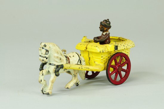 CHESTER GUMP IN PONY CART: Arcade, cast iron, yellow open cart, embossed wicker pattern, Chester figure stands in open bed, drawn by white pony, red spoke wheels. 7 1/2" l.