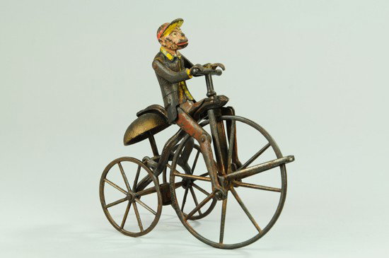 MONKEY ON TRICYCLE BELL TOY: J&E Stevens, painted cast iron animated bell ringer toy, "Patent 1883" cast in rim of large wheel, very amusing toy. 7 1/2" h.
