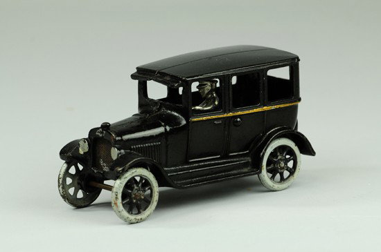 CHEVROLET "SUPERIOR" FOUR DOOR SEDAN: Arcade, cast iron, painted black, grey spoked wheels with black centers, removable nickel plated driver. 7" l.