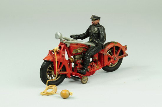 FOUR CYLINDER INDIAN MOTORCYCLE: Hubley, cast iron, done in red overall with rubber tires and clicking metal spokes, nickel plated four cylinder engine, cop driver, Hubley decal on rear fender. 9 1/2" l.