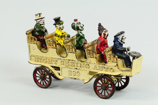 SIGHT SEEING AUTO: Kenton, c. mid teens, very whimsical open touring auto with seated comic characters, painted in white body, gold highlights, embossed "Sight Seeing Auto" on sides, red spoke wheels, the popular Captai